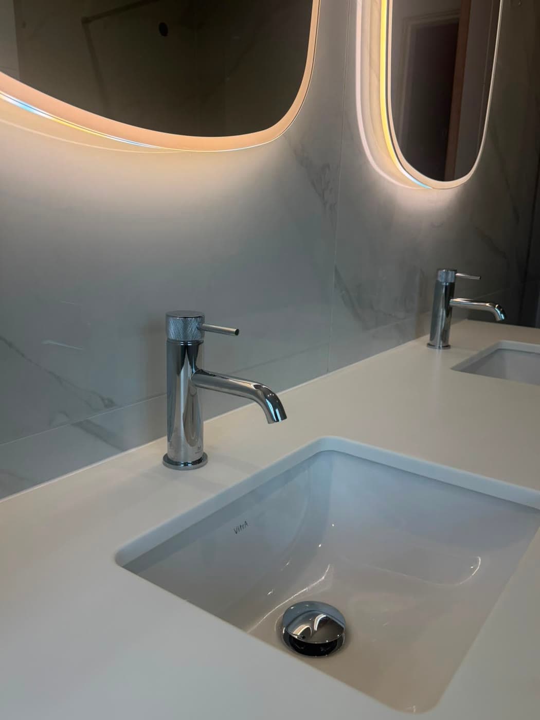 Stone tiled bathroom with brushed brass fittings and a walk-in shower, fitted by Caro Bathrooms